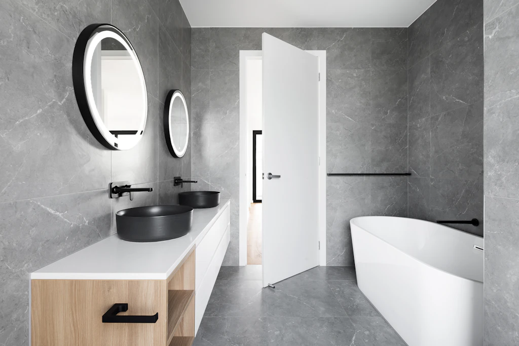 Large-format tiled bathroom with a freestanding bath