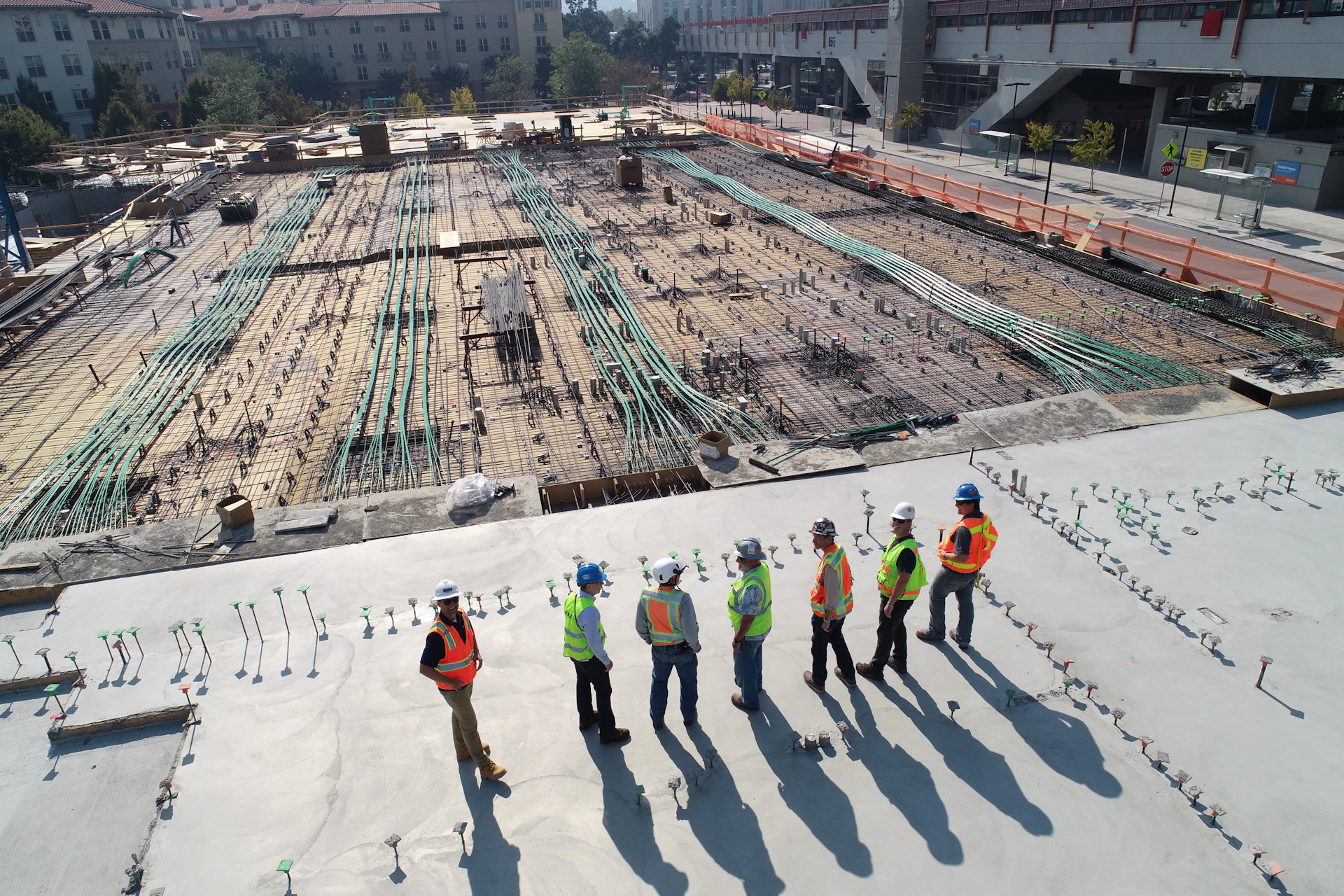 Site crew standing on a freshly poured concrete slab