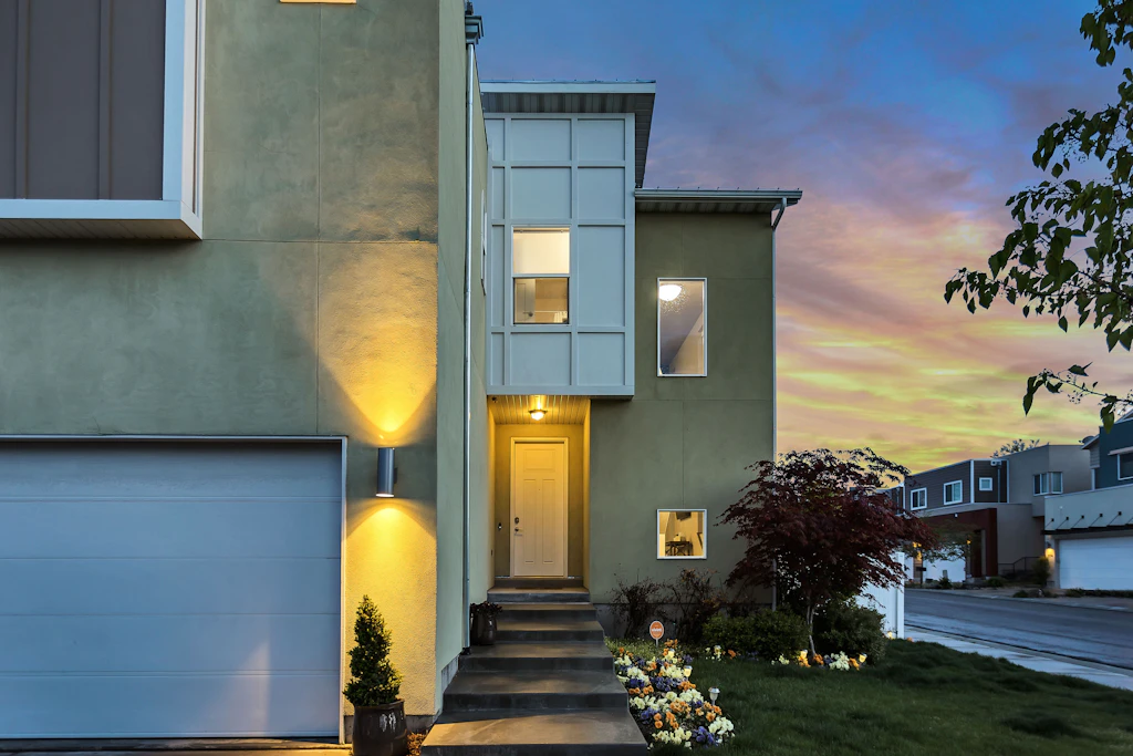 Two-storey home with warm interior lighting at dusk