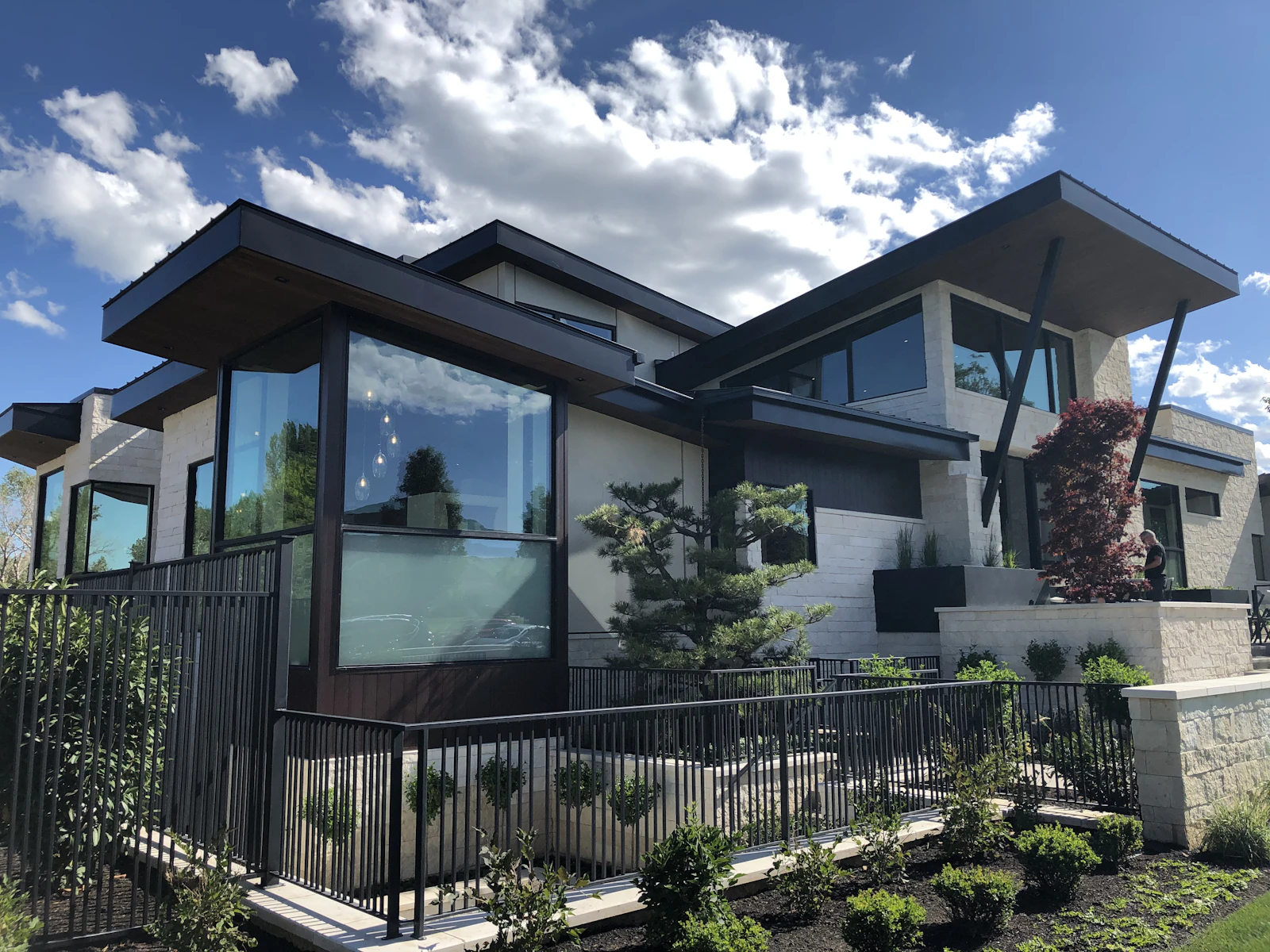 Modern home with dark framing and full-height glazing