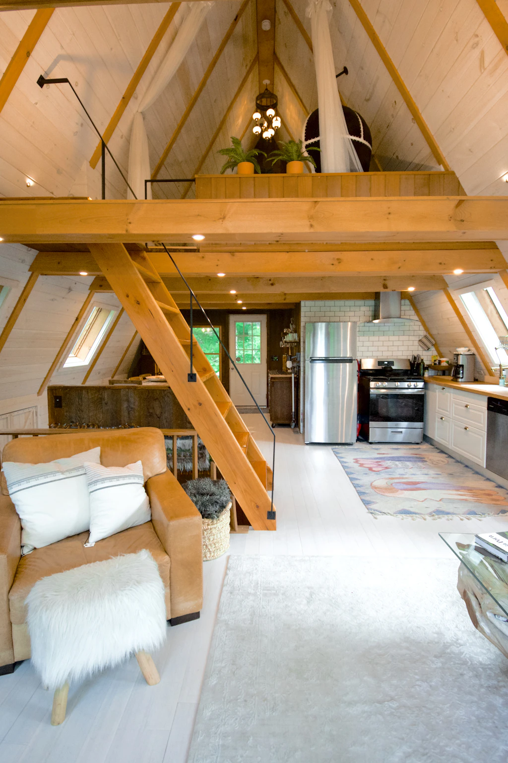 Loft bedroom under exposed timber rafters