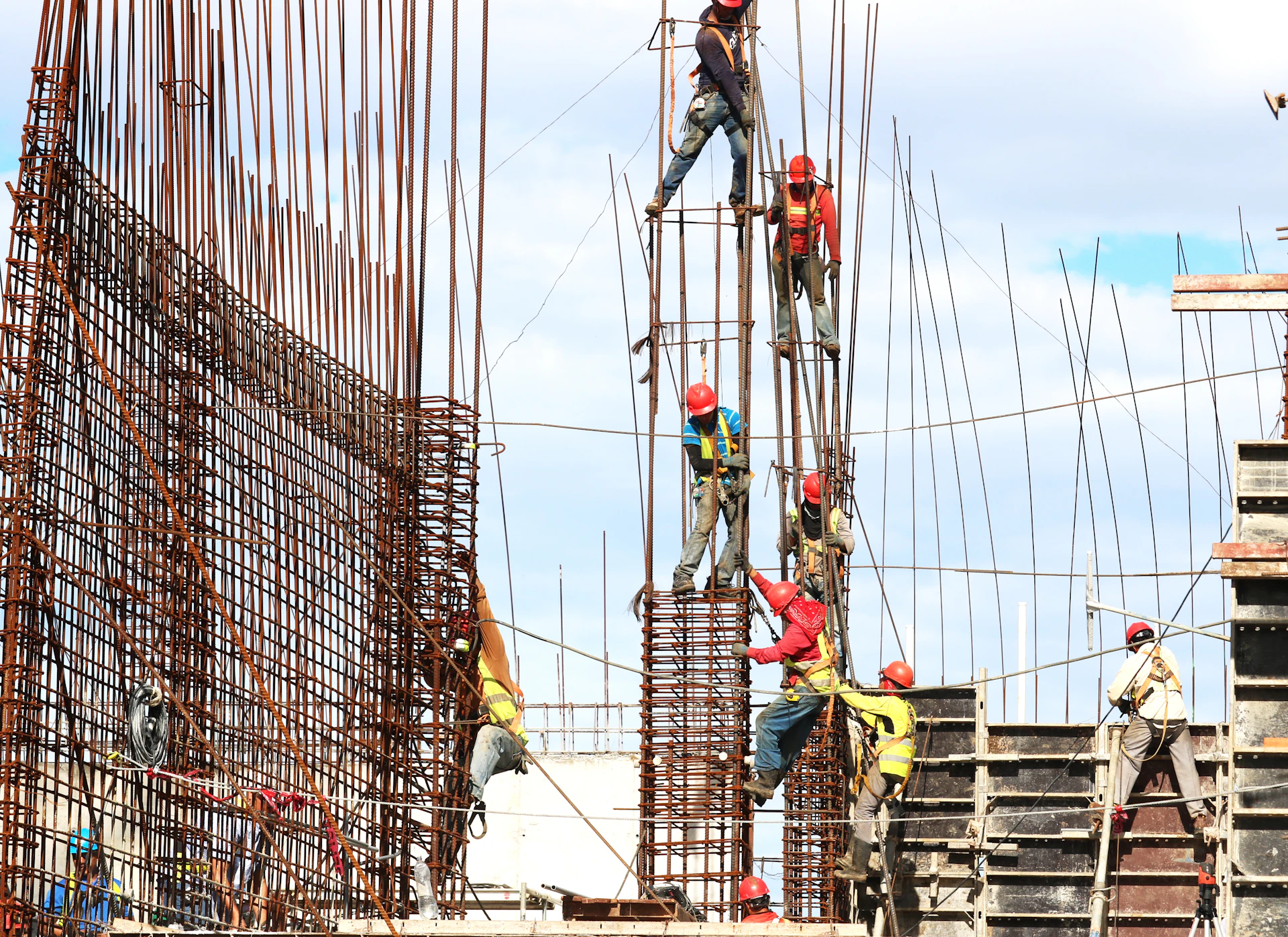 Steel fixers working across a reinforced concrete structure