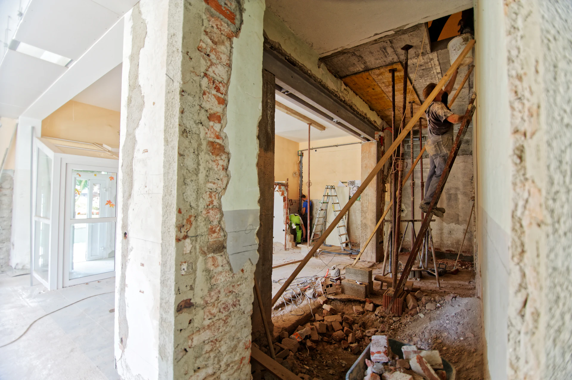 Renovation strip-out with exposed timber framing and original masonry